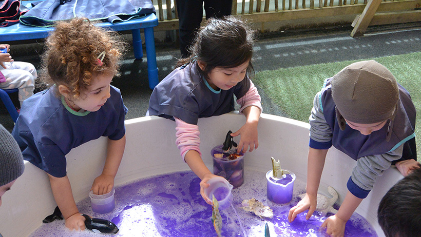 girls water play at daycare