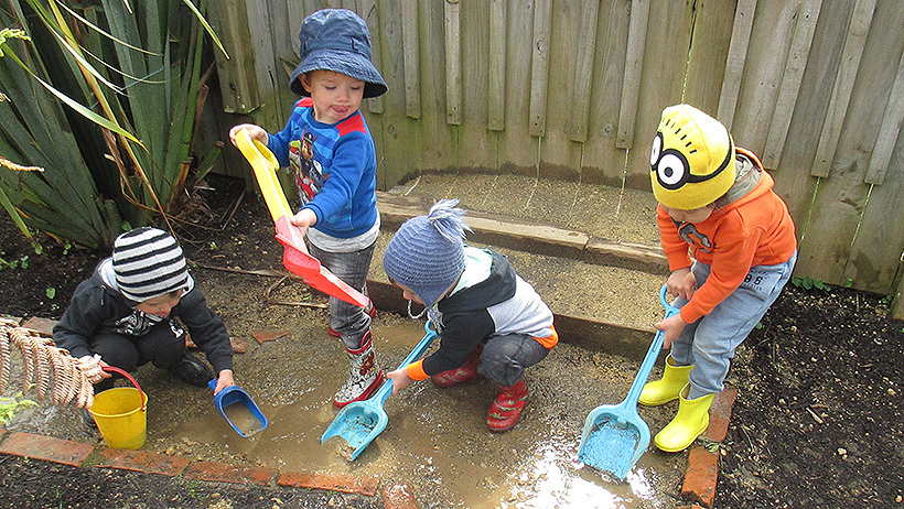 children digging in mud at daycare