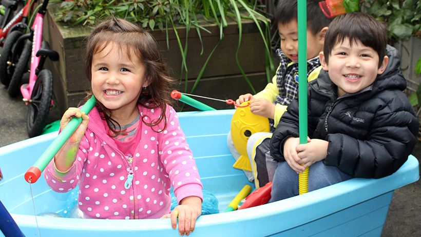 happy children sitting in boat at childcare