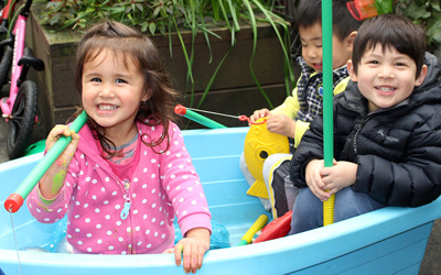 happy children sitting in boat at childcare